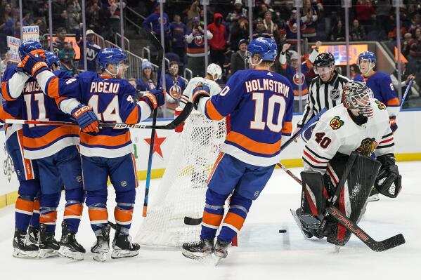 New York Islanders celebrate after scoring a goal against the Chicago Blackhawks during the second period of an NHL hockey game on Sunday, Dec. 4, 2022, in Elmont, N.Y. (AP Photo/Eduardo Munoz Alvarez)