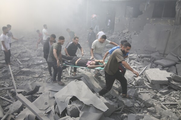 Palestinians evacuate wounded after an Israeli airstrike in Rafah refugee camp, southern Gaza Strip, Thursday, Oct. 12, 2023. (AP Photo/Hatem Ali)
