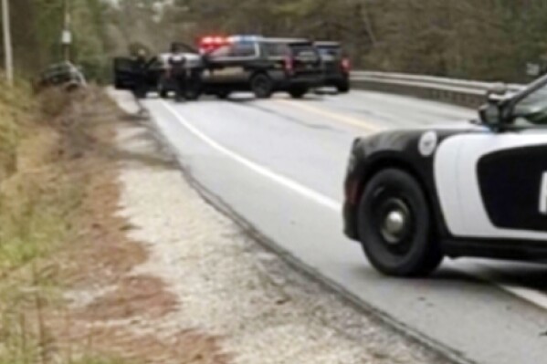 In this image taken from video, law enforcement personnel converge on a suspect, who was arrested earlier in the day and then stole a police vehicle and crashing it, before exchanging gunfire with the suspect who then stole a second police vehicle, Monday, May 6, 2024, in Paris, Maine. The Office of the Maine Attorney General said that the suspect Gary Porter was shot, treated and released from a hospital, before making initial court appearance via video on Friday, May 10, 2024, after his first court appearance was postponed because medication administered at the Cumberland County Jail made him sleepy. (Linda Marie Mercer via AP)