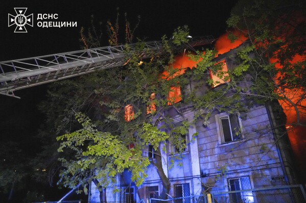 In this photo provided by the Ukrainian Emergency Service, firefighters put out the fire at an apartment house following Russia's air raid in Odesa, Ukraine, Thursday, May 1, 2025. (Ukrainian Emergency Service via AP)
