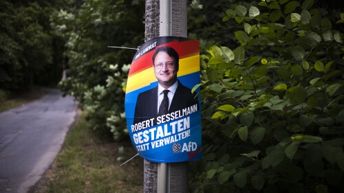 An election campaign poster of far-right AfD candidate Robert Stuhlmann hangs on a street on the outskirts of the small town of Sonneberg in the German state of Thuringia on Wednesday, July 5, 2023.  The Alternative for Germany (AfD) candidate Robert Stuhlmann won the runoff election for district mayor in the district of Sonneberg on June 25, 2023. With 56,800 inhabitants, Sonneberg has a relatively small population, but the victory is a symbolic milestone for the right-wing populist party AfD.  (AP Photo/Markus Schreiber)