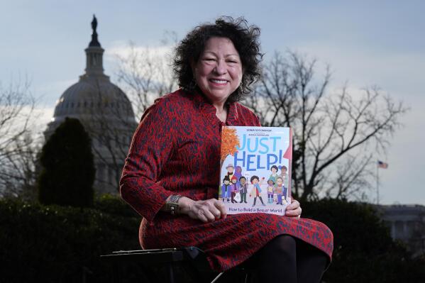 Supreme Court Associate Justice Sonia Sotomayor holds her new children's book "Just Help!" on Capitol Hill in Washington, Wednesday, Jan. 19, 2022. (AP Photo/Carolyn Kaster)