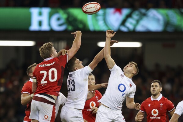 Wales' Taine Plumtree and England's Henry Slade and Jack van Poortvliet battle for the ball during the Summer Nations Series match at the Principality Stadium, Cardiff, Wales, Saturday, Aug. 5, 2023. (Simon Galloway/PA via AP)