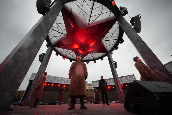 FILE - A participant dressed in Red Army World War II uniform in the role of a military traffic controller takes part in a theatrical performance at an open air interactive museum to commemorate the 82nd anniversary of the World War II-era parade, at Red Square, in Moscow, Russia, on Monday, Nov. 6, 2023. In Russia, history has long become a propaganda tool used to advance the Kremlin's political goals. In an effort to rally people around the flag, the authorities have sought to magnify the country's past victories while glossing over the more sordid chapters of its history. (AP Photo/Alexander Zemlianichenko, File)