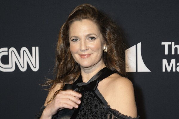 FILE - Drew Barrymore appears at the 24th Annual Mark Twain Prize for American Humor at the Kennedy Center for the Performing Arts on March 19, 2023, in Washington. Barrymore will host the National Book Awards, where Oprah Winfrey will be a guest speaker. (AP Photo/Kevin Wolf, File)