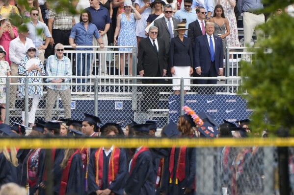 Republican presidential candidate former President Donald Trump, standing right with Melania Trump and her father, Viktor Knavs, attends a graduation ceremony for his son Barron at Oxbridge Academy Friday, May 17, 2024, in West Palm Beach, Fla. (AP Photo/Lynne Sladky)