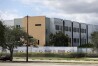 FILE - The 1200 building at Marjory Stoneman Douglas High School in Parkland, Fla., is seen, Oct. 20, 2021. Demolition of the building where 17 people died in the 2018 Parkland school shooting is set to begin, as crews will begin tearing down the three-story building at the high school on Thursday, June 13, 2024. (Carline Jean/South Florida Sun-Sentinel via AP, File)