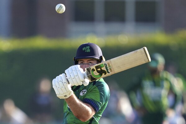 Ireland's Curtis Campher hits the winning run during the first T20 international match between Ireland and Pakistan at Castle Avenue Cricket Ground, Dublin, Ireland, Friday May 10, 2024. (Brian Lawless/PA via AP)