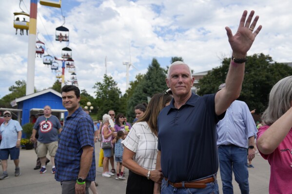 Republican presidential candidate former Vice President Mike Pence waves as he tours the grounds at the Iowa State Fair, Friday, Aug. 11, 2023, in Des Moines, Iowa. (AP Photo/Jeff Roberson)