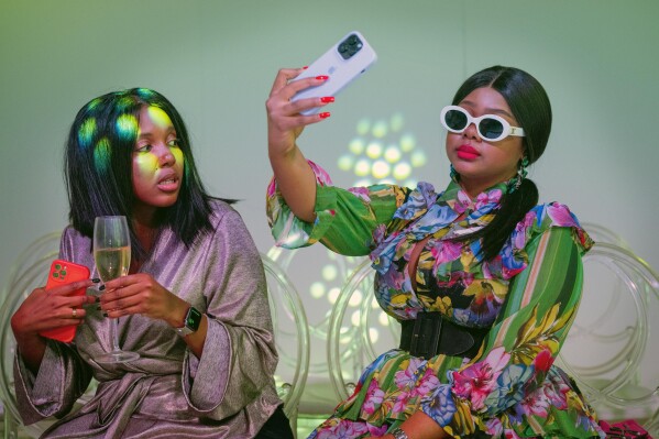 Fashionistas wait for the start of Johannesburg Fashion Week 2023 in Johannesburg, South Africa, Wednesday, Nov. 8, 2023. (AP Photo/Jerome Delay)