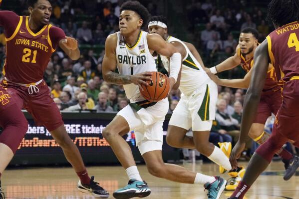 Baylor guard Keyonte George (1) drives to the basket past Iowa State center Osun Osunniyi (21) in the first half of an NCAA college basketball game, Saturday, March 4, 2023, in Waco, Texas. (Chris Jones/Waco Tribune-Herald via AP)