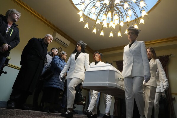 Women carry the coffin during funeral ceremonies for Lizaveta Hertsen, a 25-year-old woman from Belarus who died after being attacked and raped on the streets of the Polish capital, in Warsaw, Poland, on Thursday, March 14, 2024. The crime in a city regarded to be safe has caused shock among Poles and among Belarusians and Ukrainians who have sought refuge in Poland in recent years. (AP Photo/Czarek Sokolowski)