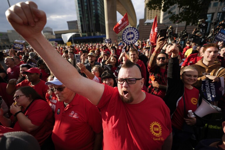United Auto Workers member Brian Rooster Heppner raises his fist as he cheers during a rally in Detroit, Friday, Sept. 15, 2023. The UAW is conducting a strike against Ford, Stellantis and General Motors. (AP Photo/Paul Sancya)