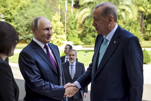 Russian President Vladimir Putin, left, greets Turkish President Recep Tayyip Erdogan upon his arrival at Russia's Black Sea resort of Sochi, Russia, Monday, Sept. 4, 2023. (Alexei Nikolsky, Sputnik, Kremlin Pool Photo via AP)