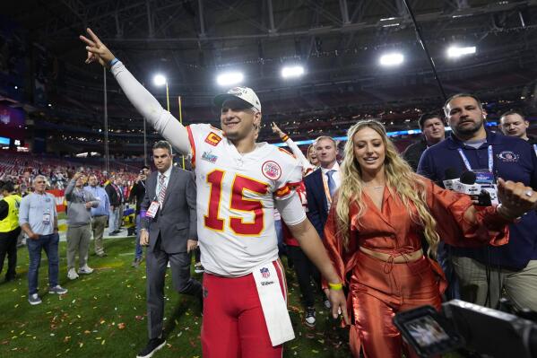 Kansas City Chiefs quarterback Patrick Mahomes (15) leaves the field with his wife, Brittany, after the NFL Super Bowl 57 football game, Sunday, Feb. 12, 2023, in Glendale, Ariz. The Chiefs defeated the Philadelphia Eagles 38-35. (AP Photo/Matt Slocum)
