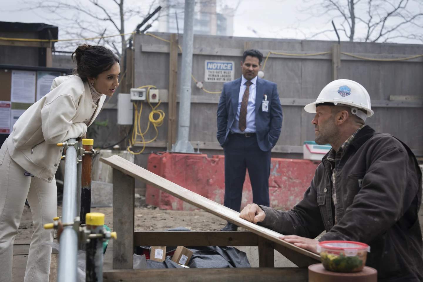 Arianna Rivers, Michael Peña and Jason Statham (left to right) in a scene from A Working Man 