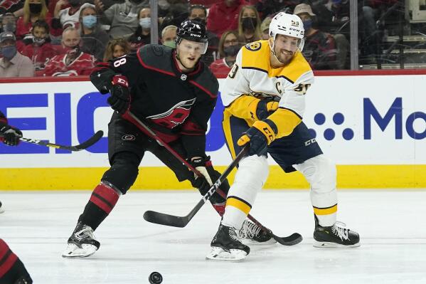 Carolina Hurricanes left wing Steven Lorentz (78) defends while Nashville Predators defenseman Roman Josi (59) passes the puck during the first period in Game 2 of an NHL hockey Stanley Cup first-round playoff series in Raleigh, N.C., Wednesday, May 19, 2021. (AP Photo/Gerry Broome)