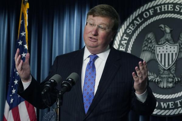Mississippi Gov. Tate Reeves answers a reporter's question after signing bills intended to improve the foster care system, speed up adoptions and provide tax credits for donations to pregnancy resource centers at a news briefing on Wednesday, April 19, 2023, at a state office building in Jackson, Miss. (AP Photo/Rogelio V. Solis)