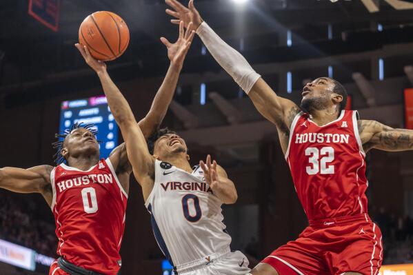 Virginia guard Kihei Clark, center, is blocked by Houston guard Marcus Sasser, left, and forward Reggie Chaney (32) during the second half of an NCAA college basketball game in Charlottesville, Va., Saturday, Dec. 17, 2022. (AP Photo/Erin Edgerton)