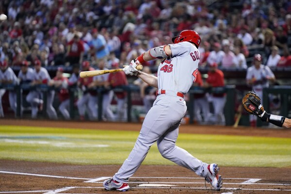 St. Louis Cardinals' Paul Goldschmidt connects for a two-run home run against the Arizona Diamondbacks during the first inning of a baseball game Monday, July 24, 2023, in Phoenix. (AP Photo/Ross D. Franklin)