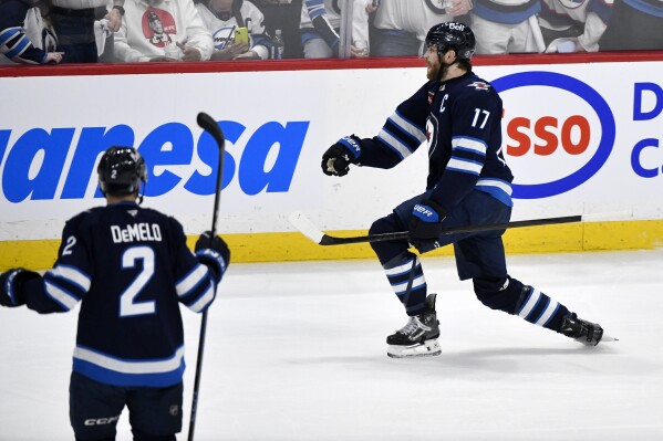Winnipeg Jets' Adam Lowry (17) celebrates after his goal against the Dallas Stars during the second period of Game 2 of a second-round NHL hockey playoff series in Winnipeg, Manitoba, Friday, May 9, 2025. (Fred Greenslade/The Canadian Press via AP)