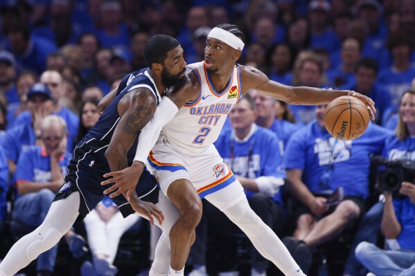 Oklahoma City Thunder guard Shai Gilgeous-Alexander (2) works the floor against Dallas Mavericks guard Kyrie Irving during the first half of Game 1 of an NBA basketball second-round playoff series, Tuesday, May 7, 2024, in Oklahoma City. (AP Photo/Nate Billings)