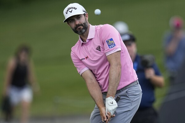 Adam Hadwin chips onto the 18th green in the first round of the Memorial golf tournament, Thursday, June 6, 2024, in Dublin, Ohio. (AP Photo/Sue Ogrocki)