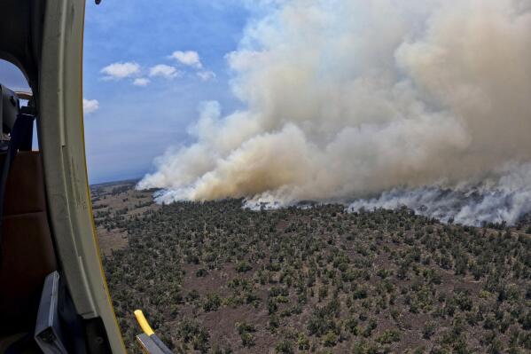 This photo provided by the Hawaii Department of Land and Natural Resources shows a large wildfire in a rural area of Hawaii's Big Island that is not threatening any homes, but high winds and extremely dry conditions are making it difficult for crews to contain the blaze. (Hawaii Department of Land and Natural Resources via AP)