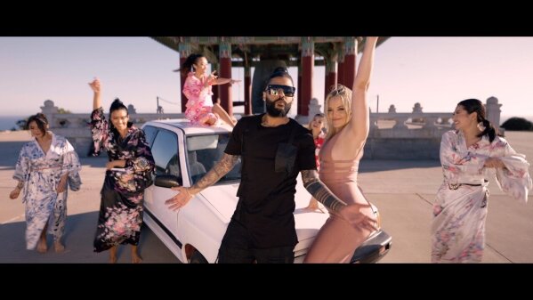 This photo provided by AZ Films shows California based Iranian pop singer Sasy with American adult film actress Alexis Texas in the music video for "Tehran Tokyo." on Feb 26, 2021 in Los Angeles.  Iranian authorities have arrested multiple music producers connected to the California-based Iranian pop singer, his management company and Iranian media said Thursday, March 11,  in Tehran’s latest effort to halt what it deems decadent Western behavior. (AZ Films via AP)