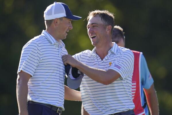Jordan Spieth and Justin Thomas speak after winning a match during their fourball match at the Presidents Cup golf tournament at the Quail Hollow Club, Friday, Sept. 23, 2022, in Charlotte, N.C. (AP Photo/Julio Cortez)