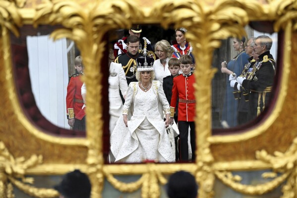 FILE - Britain's Queen Camilla leaves Westminster Abbey following her coronation ceremony, in London, Saturday, May 6, 2023. Queen Camilla, once seen as the scourge of the House of Windsor, the woman at the heart of King Charles III鈥檚 doomed marriage to the late Princess Diana, has emerged as one of the monarchy鈥檚 most prominent emissaries. With Charles and the Princess of Wales sidelined by illness, Camilla has stepped lightly into the void, increasing her schedule of appearances and taking on the all-important role of keeping the royal family firmly in the public eye 鈥� of being seen. (Toby Melville, Pool via 番茄直播, File)
