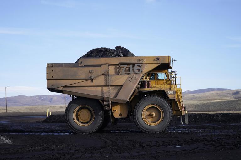 Coal is hauled from the Trapper Mine on Thursday, Nov. 18, 2021, in Craig, Colo. The coal plant in Craig is closing, along with the mine that feeds it and has nearly 115 more employees, and all the workers will lose their jobs over the next decade. (AP Photo/Rick Bowmer)