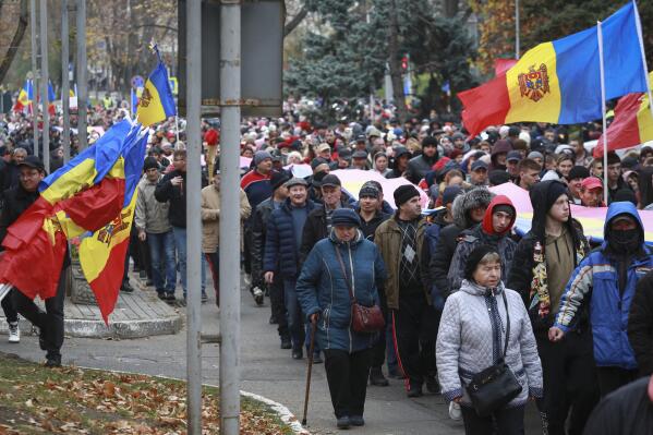 People march during a protest initiated by the populist Shor Party, calling for early elections and President Maia Sandu's resignation, in Chisinau, Moldova, Sunday, Nov. 13, 2022. Thousands of anti-government protesters returned to the streets of Moldova's capital Sunday to express their dismay over alleged government failings amid an acute winter energy crisis and skyrocketing inflation.(AP Photo/Aurel Obreja)