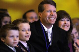 FILE - Jim Bob Duggar and his family listen as former Arkansas Gov. Mike Huckabee speaks to the Values Voter Summit, held by the Family Research Council Action, Friday, Sept. 17, 2010, in Washington. On Friday, Oct. 29, 2021, Duggar, whose large family was featured in the TLC reality show “19 Kids and Counting," has announced he's running for a seat in the Arkansas Senate. (AP Photo/Jacquelyn Martin, File)