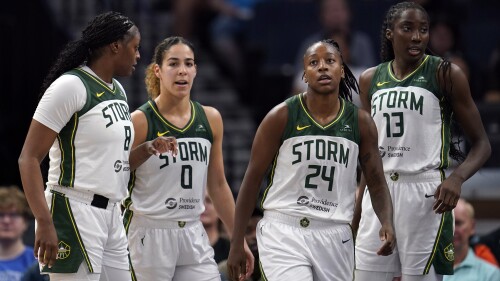 From left to right, Seattle Storm forward Joyner Holmes, guard Kia Nurse (0), guard Jewell Loyd (24) and center Ezi Magbegor (13) stand together during the second half of a WNBA basketball game against the Minnesota Lynx, Tuesday, June 27, 2023, in Minneapolis. (AP Photo/Abbie Parr)