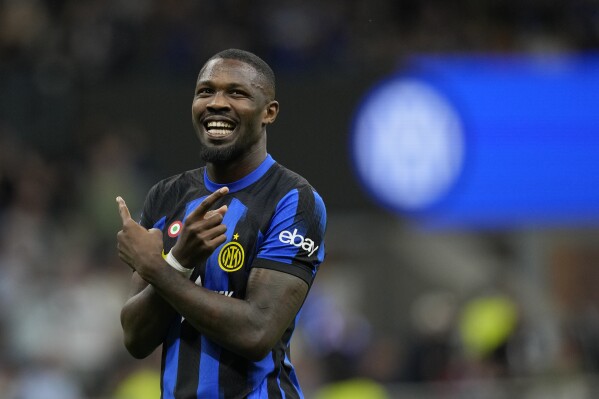 Inter Milan's Marcus Thuram celebrates after scoring his side's opening goal during the Italian Serie A soccer match between Inter Milan and Cagliari at the San Siro stadium in Milan, Italy, Sunday, April 14, 2024. (AP Photo/Antonio Calanni)