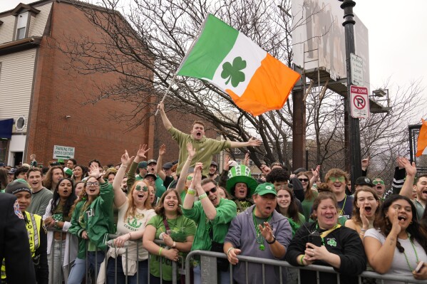 Spectators cheer at the St. Patrick's Day parade, Sunday, March 16, 2025, in Boston, Mass. (AP Photo/Robert F. Bukaty)