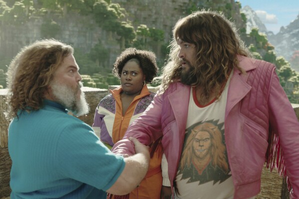This image released by Warner Bros. Pictures shows, from left, Jack Black, Danielle Brooks and Jason Momoa in a scene from "A Minecraft Movie." (Warner Bros. Pictures via AP)