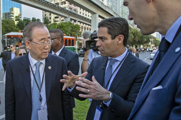 
              Miami Mayor Francis X. Suarez, center, gives former Secretary-General of the United Nations Ban Ki-moon, left, and Patrick V. Verkooijen, right, Chief Executive Officer of the Global Center on Adaptation,  a tour of Miami's sea rise adaptation measures on Tuesday, Feb. 19, 2019. (Al Diaz/Miami Herald via AP)
            