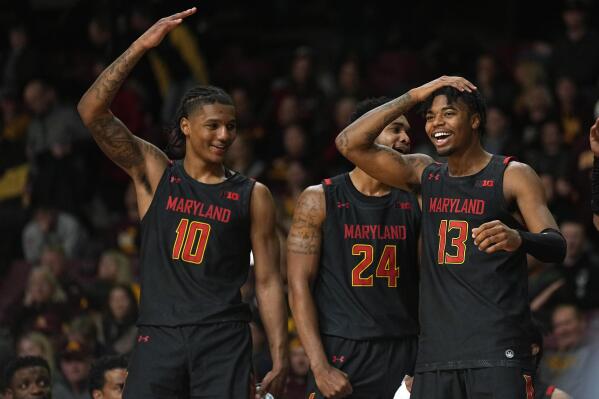 Maryland forward Julian Reese (10), forward Donta Scott (24) and guard Hakim Hart (13) celebrate after a Maryland basket during the second half of an NCAA college basketball game against Minnesota, Saturday, Feb. 4, 2023, in Minneapolis. (AP Photo/Abbie Parr)