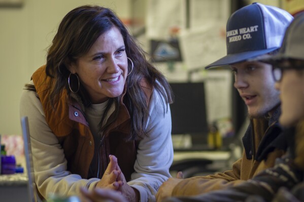 This image provided by Idaho Education News shows Brittany Ohman, an advisor for the Hope Squad, talking with Cutter Wasylow and another student during a Hope Squad class at Rigby High School in Rigby, Idaho on Wednesday, Feb. 5, 2025. (John Roark/Idaho Education News via AP)