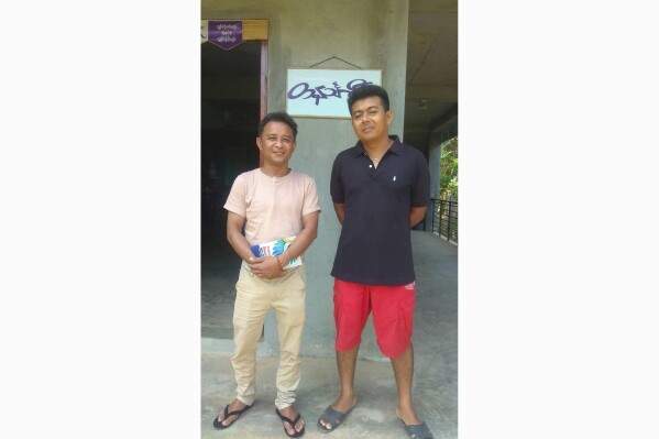 Aung San Oo, left, and Myo Myint Oo, pose for a photograph in front of the office of the Tanintharyi Weekly Journal published by Dawei Watch media, in Dawei township in Tanintharyi region, Myanmar, in 2020. Myanmar’s military government has arrested two journalists with a local online news service, their editor said Wednesday, Dec. 13, 2023 in its latest crackdown on media freedom since seizing power nearly three years ago. (Zaw Zaw (Myeik) via AP)