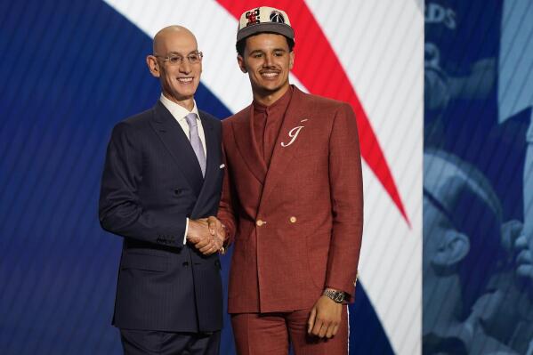 Johnny Davis shakes hands with NBA Commissioner Adam Silver after being selected 10th overall by the Washington Wizards in the NBA basketball draft, Thursday, June 23, 2022, in New York. (AP Photo/John Minchillo)