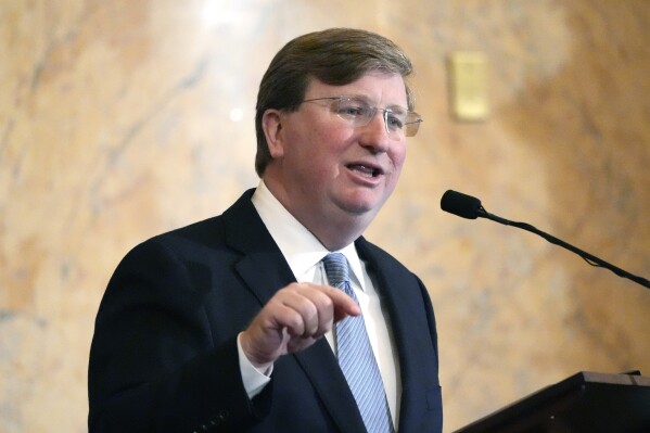 FILE - Mississippi Republican Gov. Tate Reeves delivers his State of the State address to the Mississippi State Legislature, Feb. 26, 2024, at the state Capitol in Jackson, Miss. State lawmakers from Mississippi and Alabama are playing each other in softball this weekend to raise money for charity. And, the two Republican governors are placing friendly bets on the outcome. The Battle of Tombigbee takes place Saturday, June 22 at Trustmark Park in the Jackson suburb of Pearl, to raise money for Children’s of Mississippi, a hospital in Jackson. (AP Photo/Rogelio V. Solis, File)