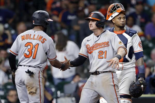 Baltimore Orioles' Cedric Mullins (31) and Austin Hays (21) celebrate in front of Houston Astros catcher Martin Maldonado, right, after they both scored on the home run by Hays during the ninth inning of a baseball game Monday, June 28, 2021, in Houston. (AP Photo/Michael Wyke)