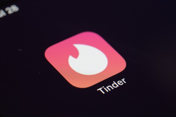 FILE - The icon for the dating app Tinder appears on a device, July 28, 2020, in New York. Tinder, Hinge and other dating apps are designed with addictive features that encourage 鈥渃ompulsive鈥� use, a proposed class action lawsuit against parent company Match Group claims. The lawsuit filed Wednesday, Feb. 14, 2024, says Match intentionally designs its dating platforms with game-like features that 鈥渓ock users into a perpetual pay-to-play loop鈥� prioritizing profit over promises to help users find relationships. (APPhoto/Patrick Sison, File)
