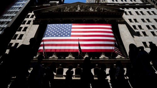 People walk past the New York Stock Exchange on Wednesday, June 29, 2022 in New York. (AP Photo/Julia Nikhinson)
