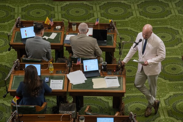 Republican state Sen. Brian Dahle, left, and Democratic assembly member Buffy Wicks discuss a measure as the Legislature voted on the state budget bills at the Capitol in Sacramento, Calif., Wednesday, June 26, 2024. Lawmakers passed the budget bills that closed a multi-billion dollar deficit and sent it to the governor. (AP Photo/Rich Pedroncelli)