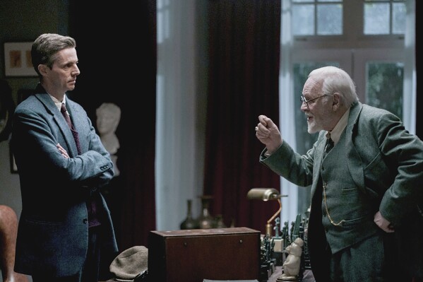 This image provided by Sony Pictures Classics shows Matthew Goode as C.S. Lewis and Anthony Hopkins as Sigmund Freud in a scene from "Freud's Last Session." (Sabrina Lantos/Sony Pictures Classics via AP)