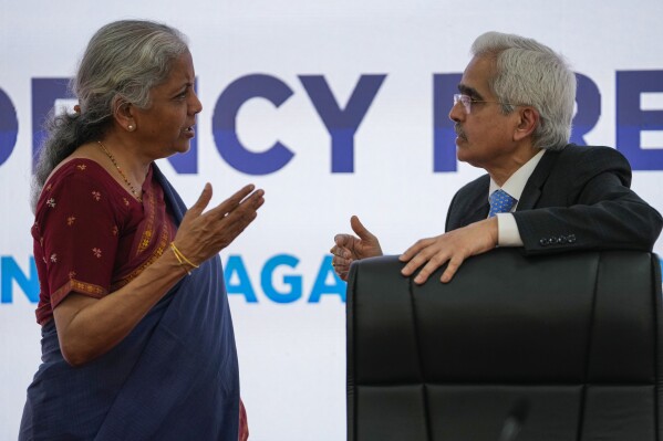 Indian Finance Minister Nirmala Sitharaman, left and Reserve Bank of India governor Shaktikanta Das, talk as they arrive to address the media after a meeting of finance chiefs and central bank governors of the Group of 20 leading economies in Gandhinagar, India, Tuesday, July 18, 2023. (AP Photo/Ajit Solanki)